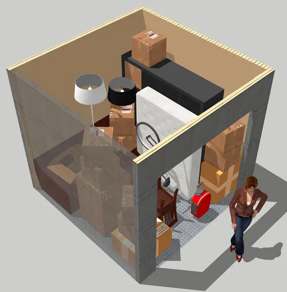 A person standing in the middle of a room with boxes.