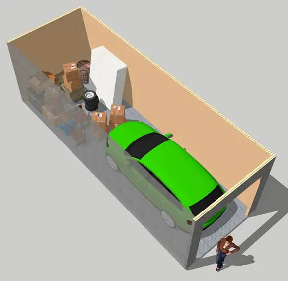 A green car is in the back of a garage.